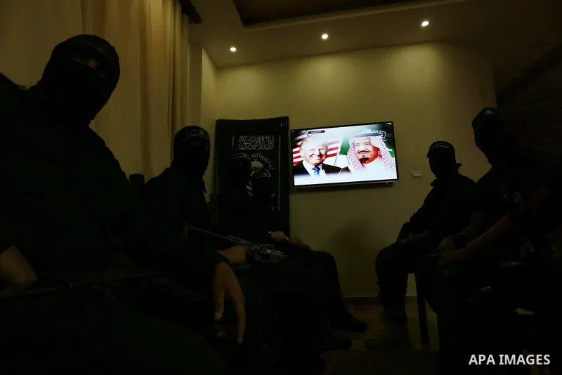 Palestinian militants of the Nasser Salah al-Din Brigades the military wing of the Popular Resistance movement watch the opening session of the Arab American Islamic summit held in the Saudi capital Riyadh, with the part...