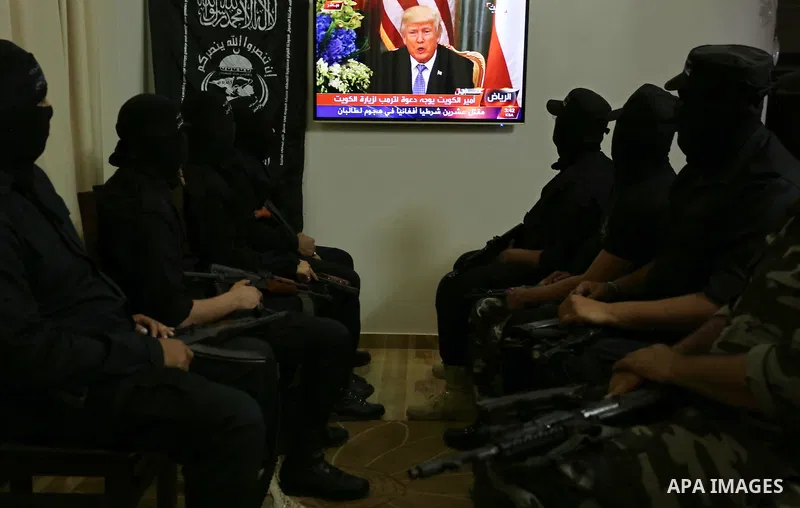 Palestinian militants of the Nasser Salah al-Din Brigades the military wing of the Popular Resistance movement watch the opening session of the Arab American Islamic summit held in the Saudi capital Riyadh, with the part...