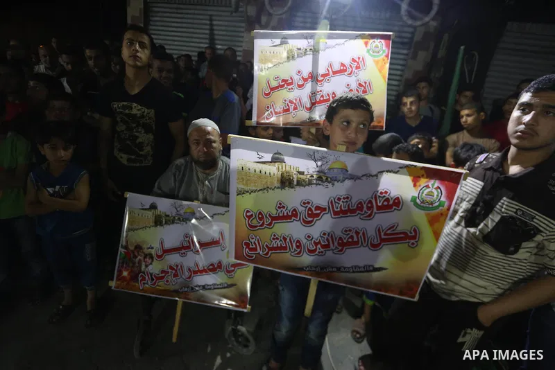 Supporters of the Palestinian Hamas movement hold banners during a protest against U.S. President Donald Trump comments linking Hamas with terrorism in Jabalia refugee camp in the northern Gaza Strip on May 22, 2017. Pho...