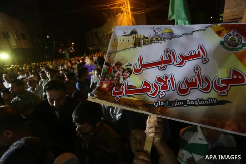 Supporters of the Palestinian Hamas movement hold banners during a protest against U.S. President Donald Trump comments linking Hamas with terrorism in Jabalia refugee camp in the northern Gaza Strip on May 22, 2017. Pho...