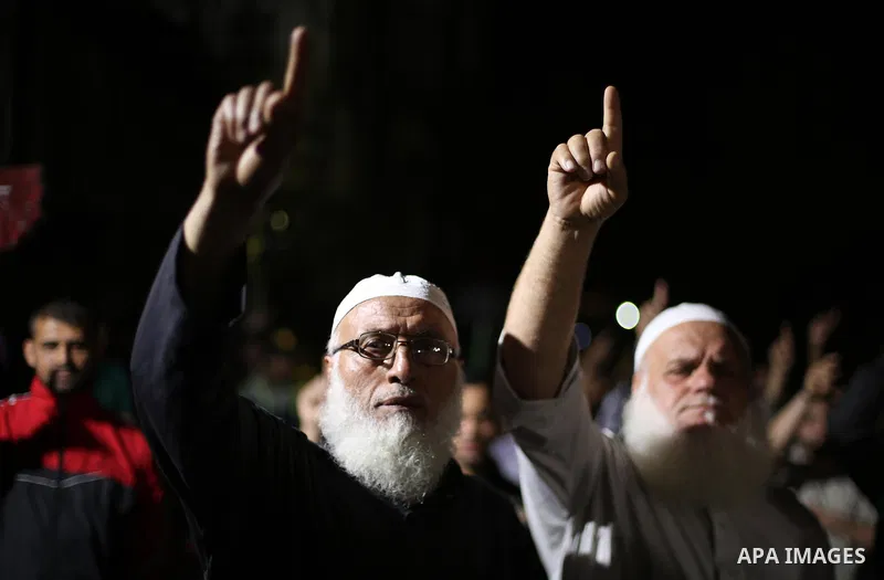 Supporters of the Palestinian Hamas movement hold banners during a protest against U.S. President Donald Trump comments linking Hamas with terrorism in Jabalia refugee camp in the northern Gaza Strip on May 22, 2017. Pho...