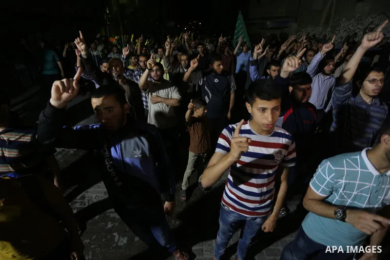 Supporters of the Palestinian Hamas movement hold banners during a protest against U.S. President Donald Trump comments linking Hamas with terrorism in Jabalia refugee camp in the northern Gaza Strip on May 22, 2017. Pho...