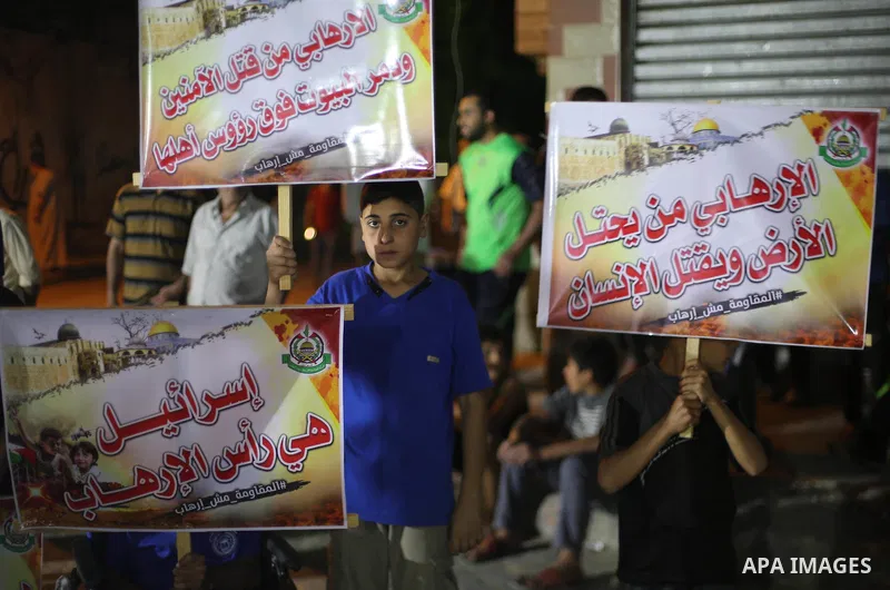 Supporters of the Palestinian Hamas movement hold banners during a protest against U.S. President Donald Trump comments linking Hamas with terrorism in Jabalia refugee camp in the northern Gaza Strip on May 22, 2017. Pho...