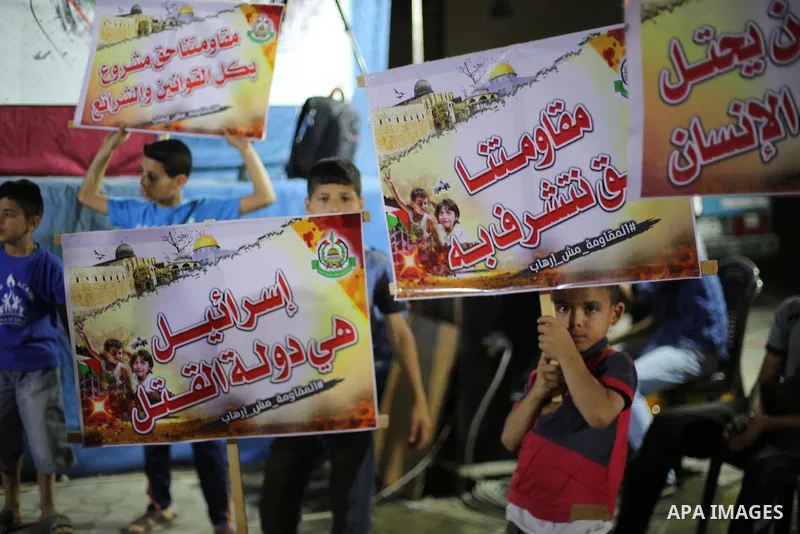 Supporters of the Palestinian Hamas movement hold banners during a protest against U.S. President Donald Trump comments linking Hamas with terrorism in Jabalia refugee camp in the northern Gaza Strip on May 22, 2017. Pho...