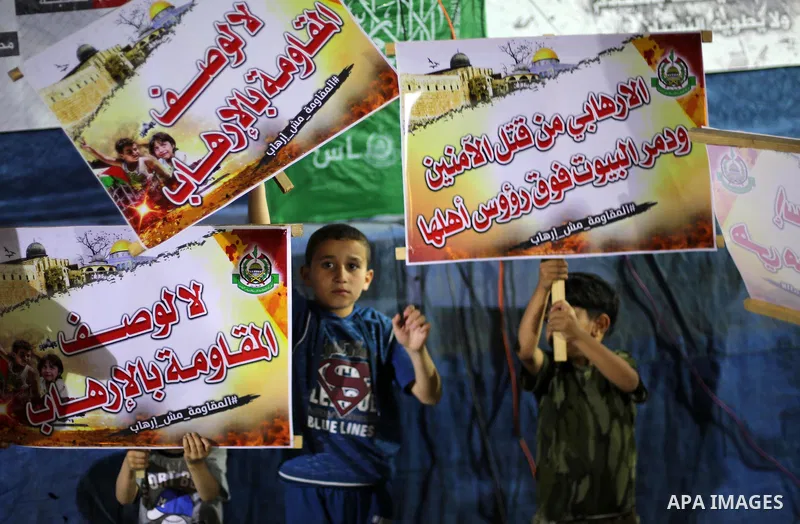 Supporters of the Palestinian Hamas movement hold banners during a protest against U.S. President Donald Trump comments linking Hamas with terrorism in Jabalia refugee camp in the northern Gaza Strip on May 22, 2017. Pho...