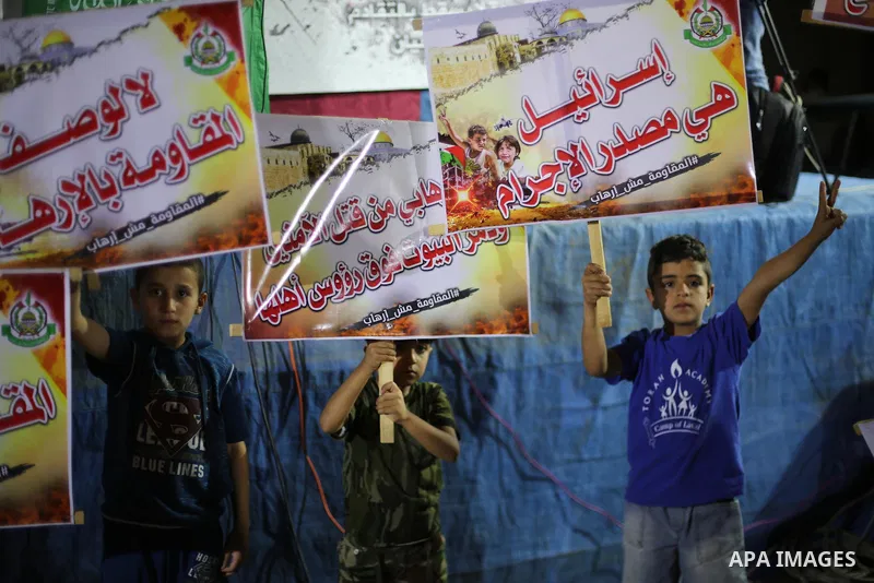 Supporters of the Palestinian Hamas movement hold banners during a protest against U.S. President Donald Trump comments linking Hamas with terrorism in Jabalia refugee camp in the northern Gaza Strip on May 22, 2017. Pho...