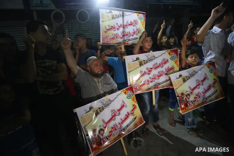 Supporters of the Palestinian Hamas movement hold banners during a protest against U.S. President Donald Trump comments linking Hamas with terrorism in Jabalia refugee camp in the northern Gaza Strip on May 22, 2017. Pho...