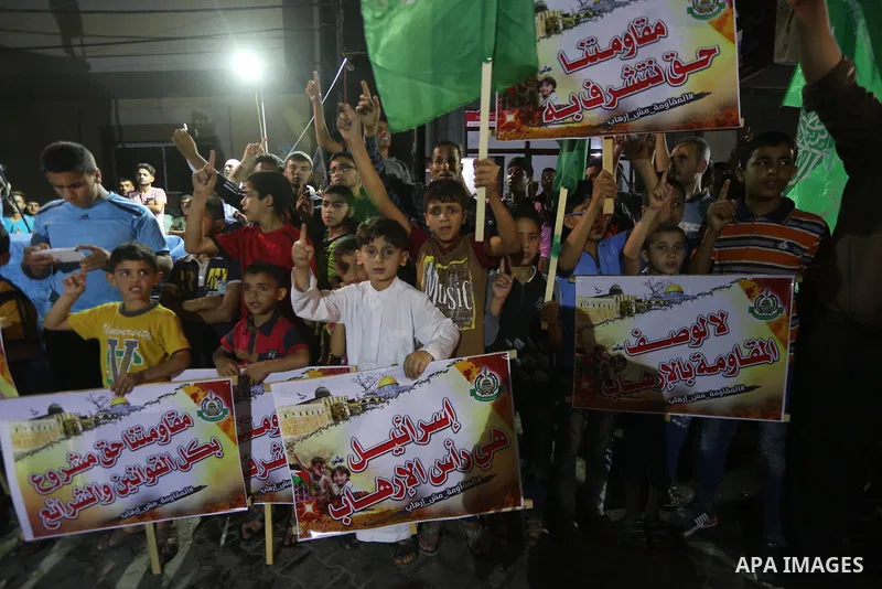 Supporters of the Palestinian Hamas movement hold banners during a protest against U.S. President Donald Trump comments linking Hamas with terrorism in Jabalia refugee camp in the northern Gaza Strip on May 22, 2017. Pho...