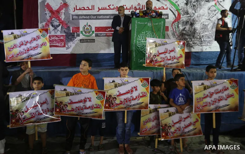 Supporters of the Palestinian Hamas movement hold banners during a protest against U.S. President Donald Trump comments linking Hamas with terrorism in Jabalia refugee camp in the northern Gaza Strip on May 22, 2017. Pho...