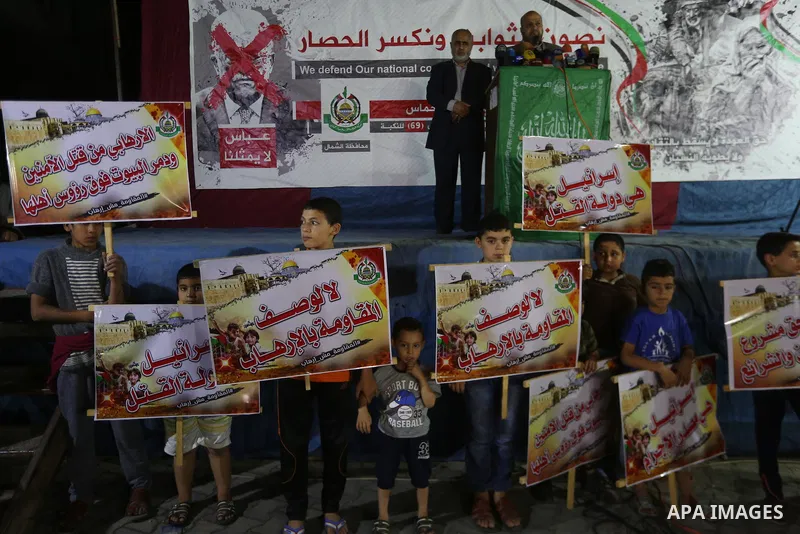 Supporters of the Palestinian Hamas movement hold banners during a protest against U.S. President Donald Trump comments linking Hamas with terrorism in Jabalia refugee camp in the northern Gaza Strip on May 22, 2017. Pho...