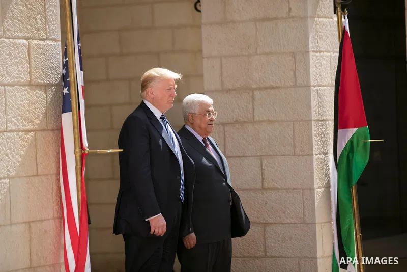 U.S. President Donald Trump and Palestinian President Mahmoud Abbas review the honor guard during a reception ceremony at the presidential headquarters in the West Bank town of Bethlehem, May 23, 2017. APAIMAGES/Fadi Aro...