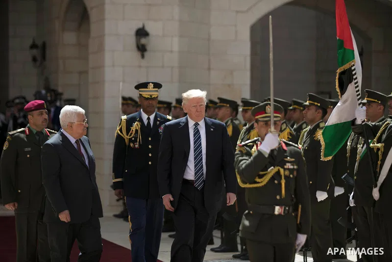 U.S. President Donald Trump and Palestinian President Mahmoud Abbas review the honor guard during a reception ceremony at the presidential headquarters in the West Bank town of Bethlehem, May 23, 2017. APAIMAGES/Fadi Aro...
