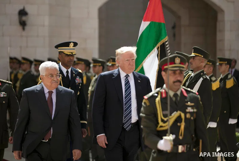 U.S. President Donald Trump and Palestinian President Mahmoud Abbas review the honor guard during a reception ceremony at the presidential headquarters in the West Bank town of Bethlehem, May 23, 2017. APAIMAGES/Fadi Aro...