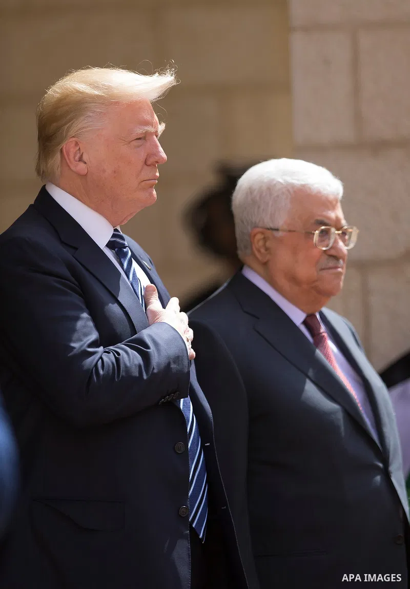 U.S. President Donald Trump and Palestinian President Mahmoud Abbas review the honor guard during a reception ceremony at the presidential headquarters in the West Bank town of Bethlehem, May 23, 2017. APAIMAGES/Fadi Aro...