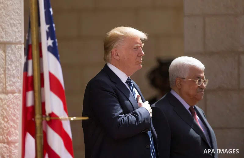 U.S. President Donald Trump and Palestinian President Mahmoud Abbas review the honor guard during a reception ceremony at the presidential headquarters in the West Bank town of Bethlehem, May 23, 2017. APAIMAGES/Fadi Aro...