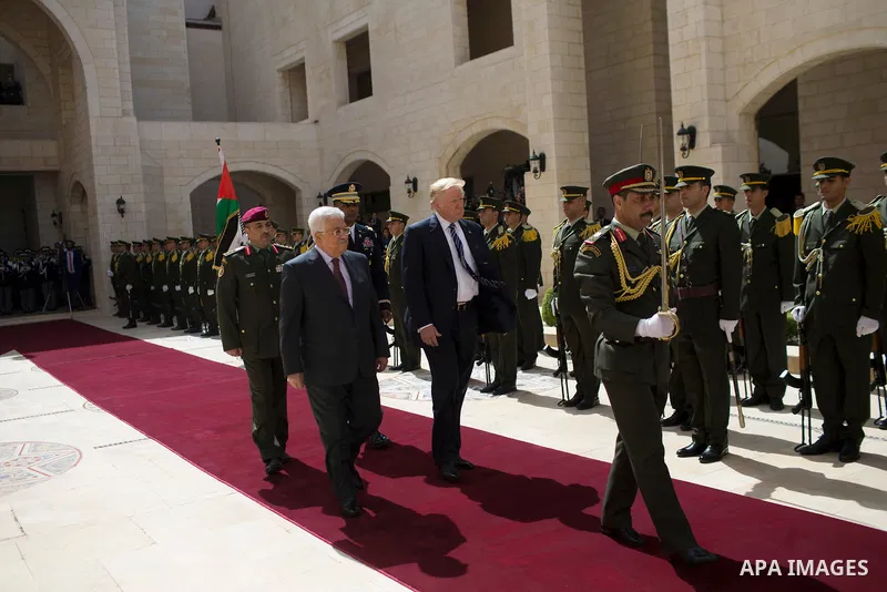 U.S. President Donald Trump and Palestinian President Mahmoud Abbas review the honor guard during a reception ceremony at the presidential headquarters in the West Bank town of Bethlehem, May 23, 2017. APAIMAGES/Fadi Aro...
