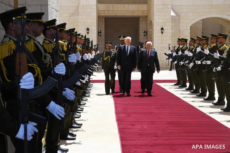 U.S. President Donald Trump and Palestinian President Mahmoud Abbas review the honor guard during a reception ceremony at the presidential headquarters in the West Bank town of Bethlehem, May 23, 2017. Photo by Thaer Gan...