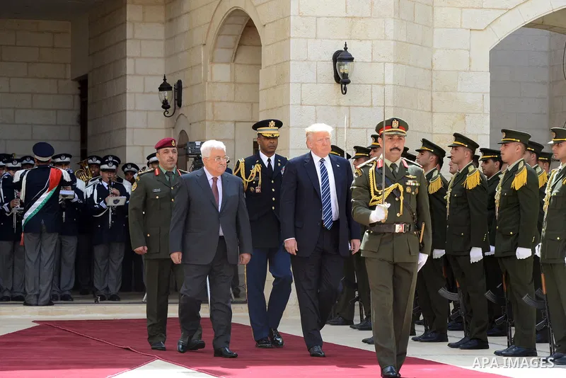 U.S. President Donald Trump and Palestinian President Mahmoud Abbas review the honor guard during a reception ceremony at the presidential headquarters in the West Bank town of Bethlehem, May 23, 2017. Photo by Thaer Gan...