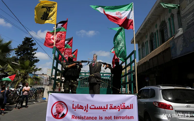 Palestinian militants from the Popular Front for the Liberation of Palestine (PFLP) aim their weapons at an effigy depicting U.S. President Donald Trump, in Gaza City May 23, 2017. Photo by Ashraf Amra