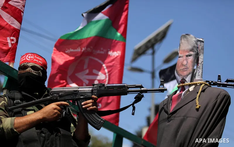 Palestinian militants from the Popular Front for the Liberation of Palestine (PFLP) aim their weapons at an effigy depicting U.S. President Donald Trump, in Gaza City May 23, 2017. Photo by Ashraf Amra