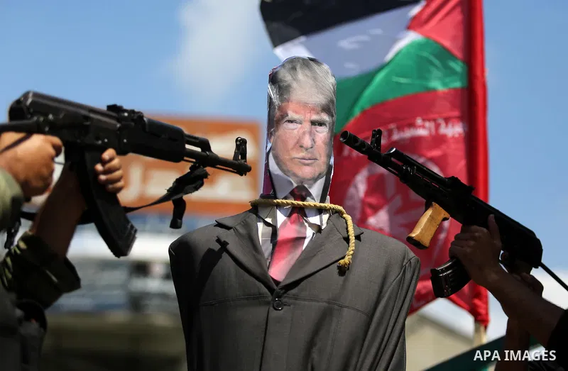 Palestinian militants from the Popular Front for the Liberation of Palestine (PFLP) aim their weapons at an effigy depicting U.S. President Donald Trump, in Gaza City May 23, 2017. Photo by Ashraf Amra
