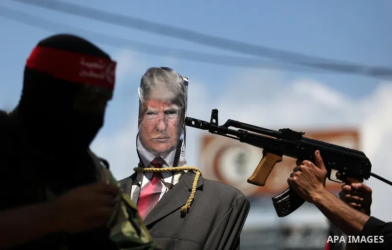 Palestinian militants from the Popular Front for the Liberation of Palestine (PFLP) aim their weapons at an effigy depicting U.S. President Donald Trump, in Gaza City May 23, 2017. Photo by Ashraf Amra