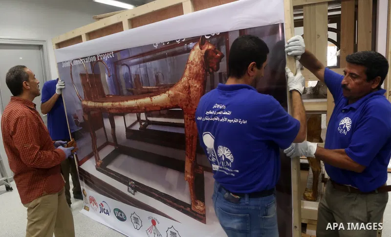 Egyptian workers open a box containing the funerary bed of ancient King Tutankhamun at the Grand Egyptian Museum (GEM) near the Pyramids Plateau in Giza, Egypt on May 23, 2017. The Egyptian Ministry of Antiquities moved...