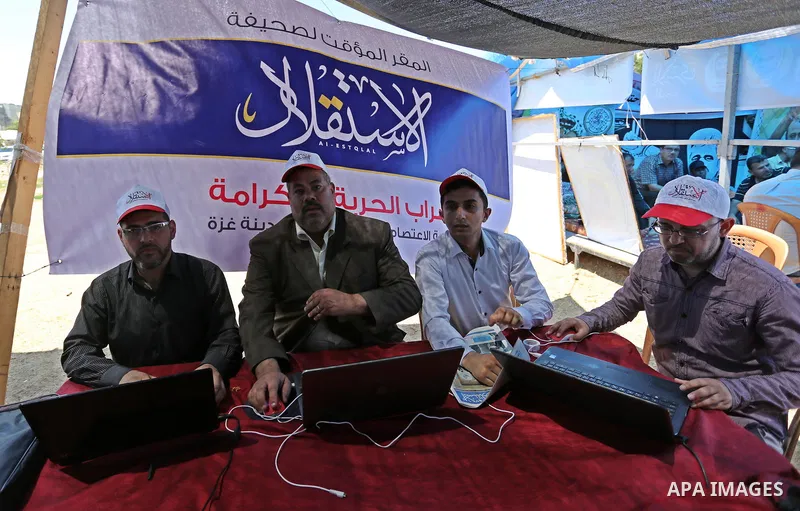 Palestinian Journalists from al-Estqlal newspaper work on printing special edition about Palestinian hunger-striking prisoners held in Israeli jails to solidarity with them at protest tent in Gaza city on May 24, 2017. P...