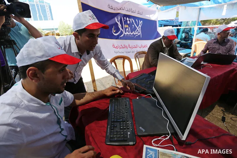 Palestinian Journalists from al-Estqlal newspaper work on printing special edition about Palestinian hunger-striking prisoners held in Israeli jails to solidarity with them at protest tent in Gaza city on May 24, 2017. P...