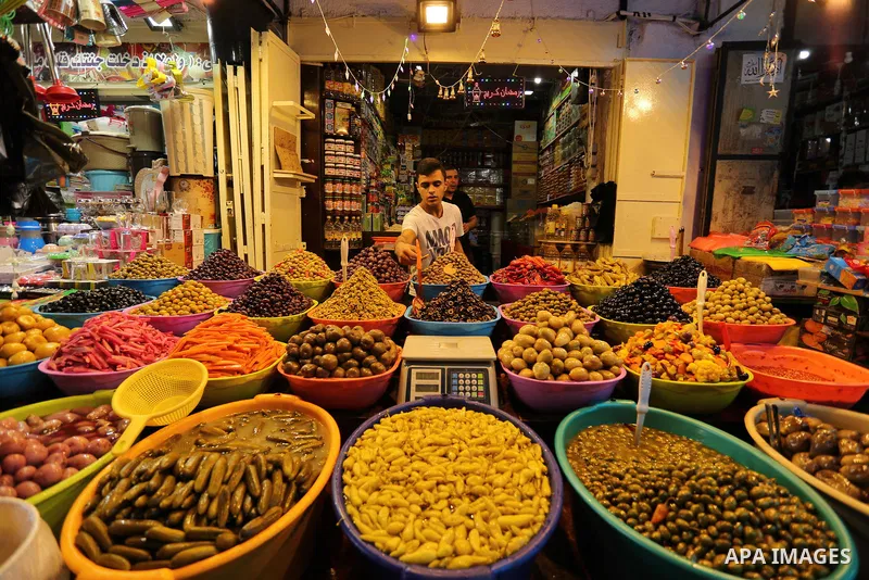A Palestinian vendor sells pickles at a market ahead of the Muslim holy month of Ramadan, in Gaza city, on May 25, 2017 as the faithful prepare to start fasting. Photo by Ashraf Amra
