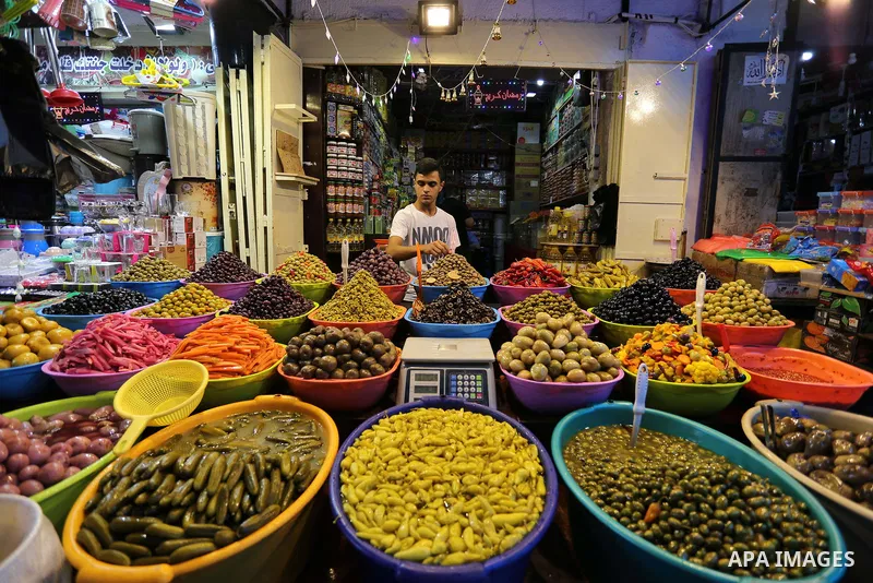 A Palestinian vendor sells pickles at a market ahead of the Muslim holy month of Ramadan, in Gaza city, on May 25, 2017 as the faithful prepare to start fasting. Photo by Ashraf Amra