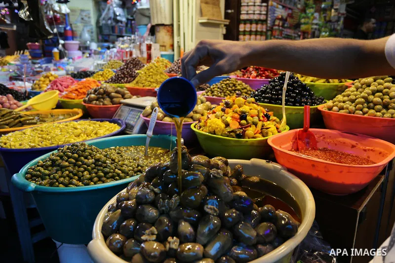 A Palestinian vendor sells pickles at a market ahead of the Muslim holy month of Ramadan, in Gaza city, on May 25, 2017 as the faithful prepare to start fasting. Photo by Ashraf Amra