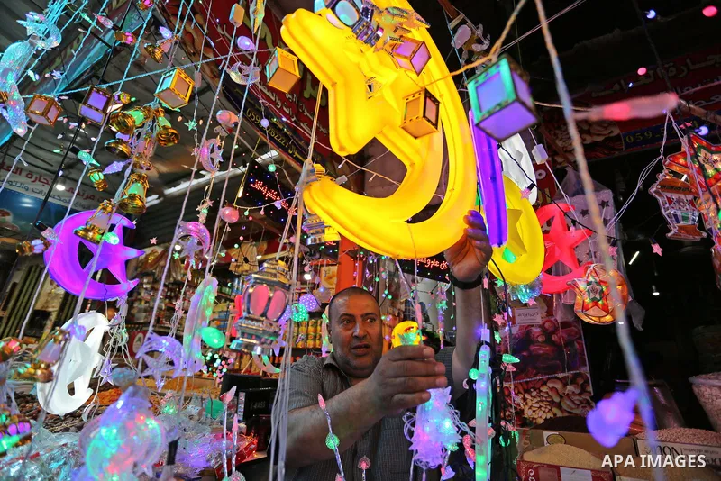 A Palestinian vendor displays traditional lanterns known in Arabic as "Fanous" at a market ahead of the Muslim holy month of Ramadan, in Gaza city, on May 25, 2017 as the faithful prepare to start fasting. Photo by Ashra...