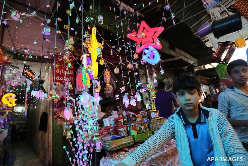 A Palestinian vendor displays traditional lanterns known in Arabic as "Fanous" at a market ahead of the Muslim holy month of Ramadan, in Gaza city, on May 25, 2017 as the faithful prepare to start fasting. Photo by Ashra...