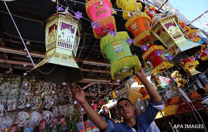 A Palestinian vendor displays traditional lanterns known in Arabic as "Fanous" at a market ahead of the Muslim holy month of Ramadan, in Gaza city, on May 25, 2017 as the faithful prepare to start fasting. Photo by Ashra...