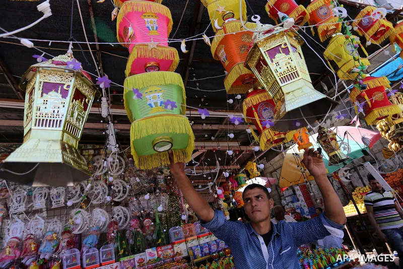 A Palestinian vendor displays traditional lanterns known in Arabic as "Fanous" at a market ahead of the Muslim holy month of Ramadan, in Gaza city, on May 25, 2017 as the faithful prepare to start fasting. Photo by Ashra...