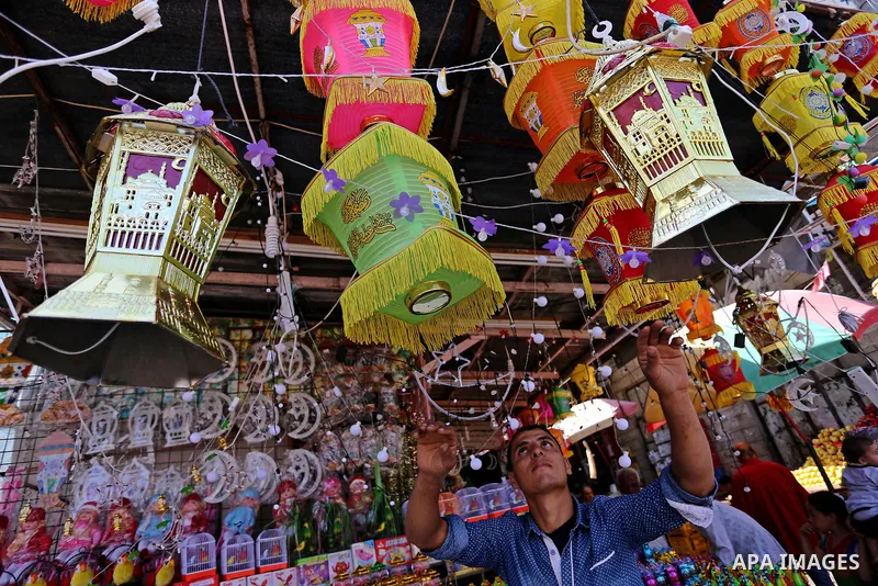 A Palestinian vendor displays traditional lanterns known in Arabic as "Fanous" at a market ahead of the Muslim holy month of Ramadan, in Gaza city, on May 25, 2017 as the faithful prepare to start fasting. Photo by Ashra...