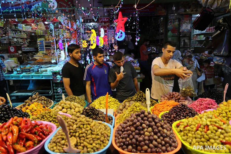 A Palestinian vendor sells pickles at a market ahead of the Muslim holy month of Ramadan, in Gaza city, on May 25, 2017 as the faithful prepare to start fasting. Photo by Ashraf Amra