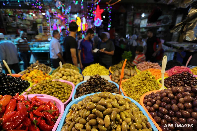 A Palestinian vendor sells pickles at a market ahead of the Muslim holy month of Ramadan, in Gaza city, on May 25, 2017 as the faithful prepare to start fasting. Photo by Ashraf Amra