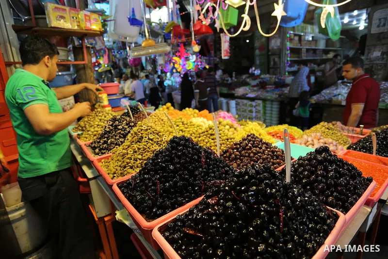 A Palestinian vendor sells pickles at a market ahead of the Muslim holy month of Ramadan, in Gaza city, on May 25, 2017 as the faithful prepare to start fasting. Photo by Ashraf Amra