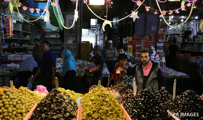 A Palestinian vendor sells pickles at a market ahead of the Muslim holy month of Ramadan, in Gaza city, on May 25, 2017 as the faithful prepare to start fasting. Photo by Ashraf Amra