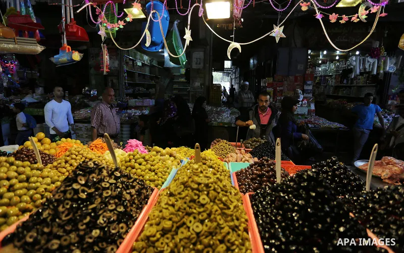 A Palestinian vendor sells pickles at a market ahead of the Muslim holy month of Ramadan, in Gaza city, on May 25, 2017 as the faithful prepare to start fasting. Photo by Ashraf Amra