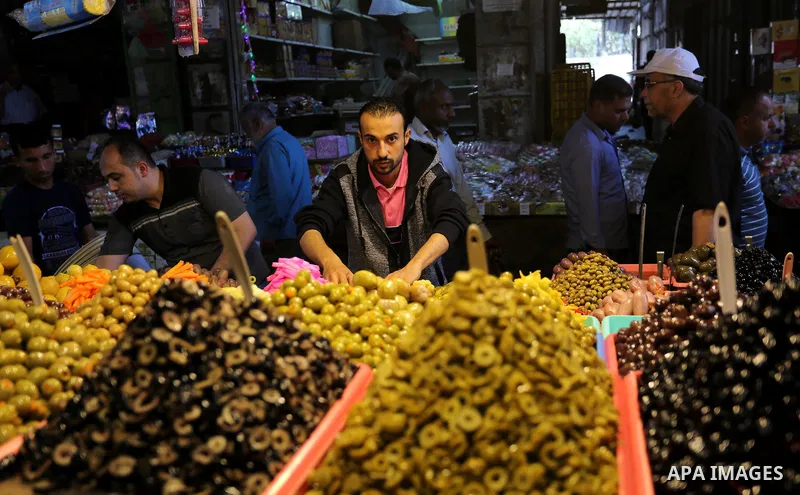 A Palestinian vendor sells pickles at a market ahead of the Muslim holy month of Ramadan, in Gaza city, on May 25, 2017 as the faithful prepare to start fasting. Photo by Ashraf Amra