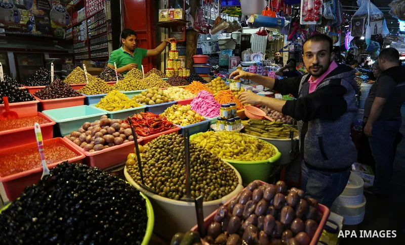 A Palestinian vendor sells pickles at a market ahead of the Muslim holy month of Ramadan, in Gaza city, on May 25, 2017 as the faithful prepare to start fasting. Photo by Ashraf Amra
