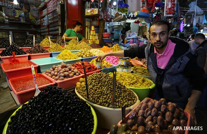 A Palestinian vendor sells pickles at a market ahead of the Muslim holy month of Ramadan, in Gaza city, on May 25, 2017 as the faithful prepare to start fasting. Photo by Ashraf Amra