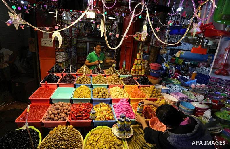 A Palestinian vendor sells pickles at a market ahead of the Muslim holy month of Ramadan, in Gaza city, on May 25, 2017 as the faithful prepare to start fasting. Photo by Ashraf Amra
