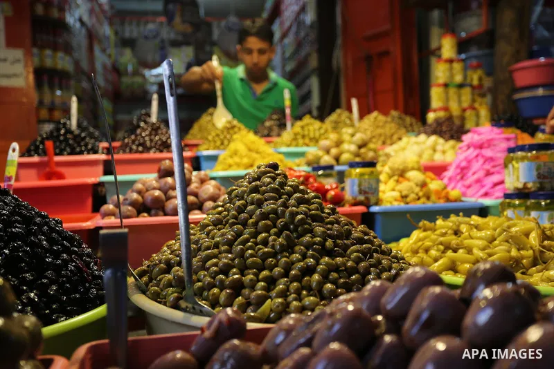 A Palestinian vendor sells pickles at a market ahead of the Muslim holy month of Ramadan, in Gaza city, on May 25, 2017 as the faithful prepare to start fasting. Photo by Ashraf Amra