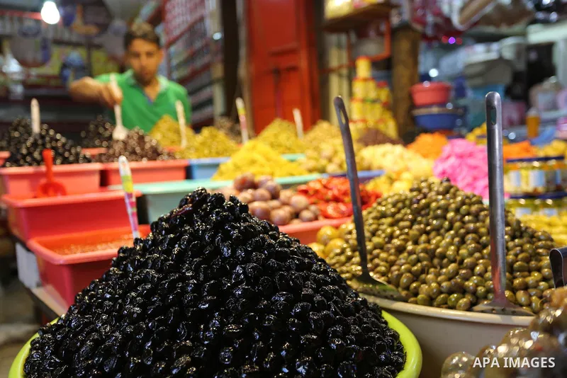 A Palestinian vendor sells pickles at a market ahead of the Muslim holy month of Ramadan, in Gaza city, on May 25, 2017 as the faithful prepare to start fasting. Photo by Ashraf Amra
