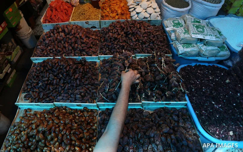 A Palestinian vendor sells dates at a market ahead of the Muslim holy month of Ramadan, in Gaza city, on May 25, 2017 as the faithful prepare to start fasting. Photo by Ashraf Amra