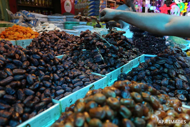 A Palestinian vendor sells dates at a market ahead of the Muslim holy month of Ramadan, in Gaza city, on May 25, 2017 as the faithful prepare to start fasting. Photo by Ashraf Amra